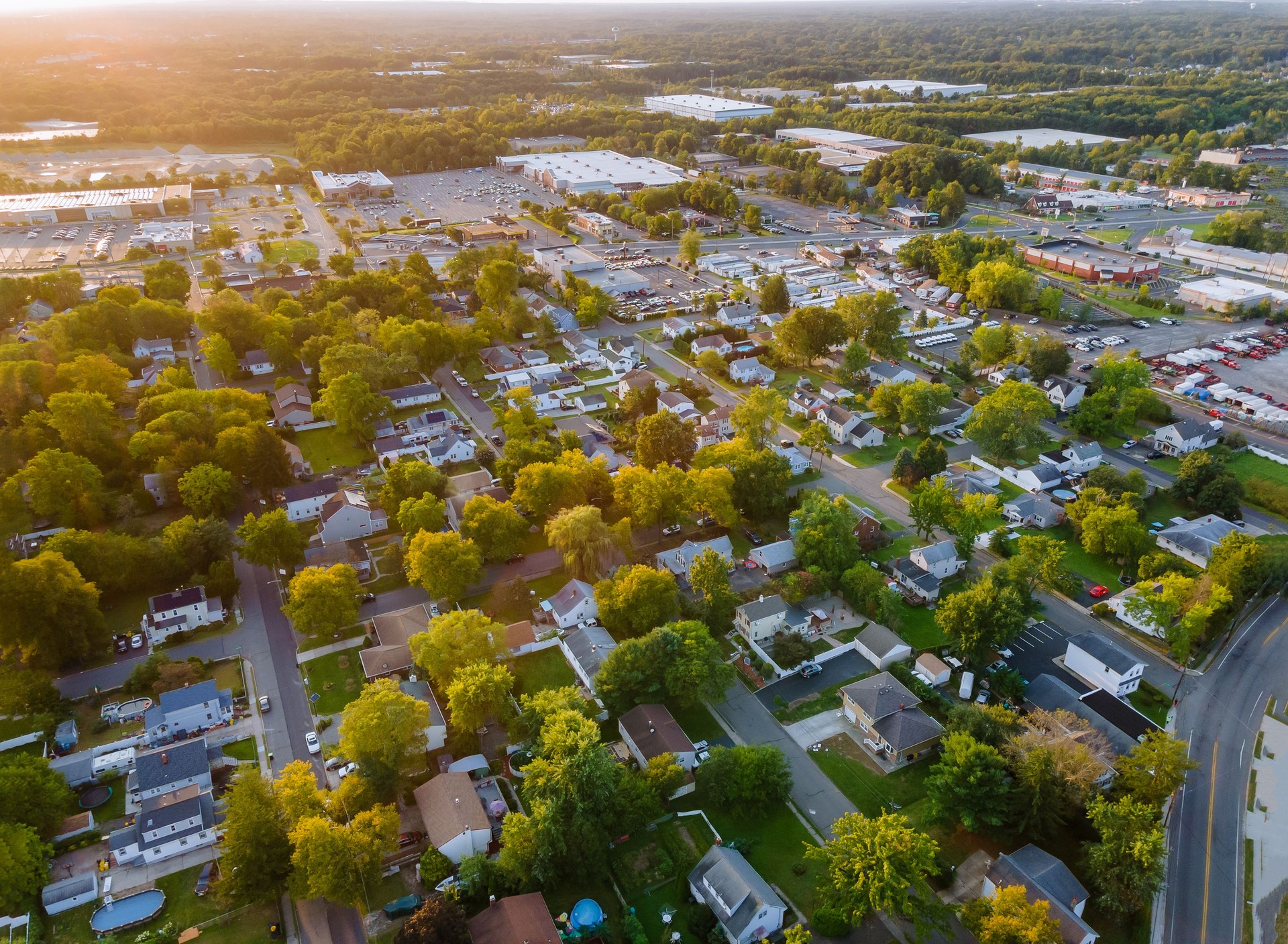 Incredible view from a height to a small town in houses and shopping mall of parking lot space